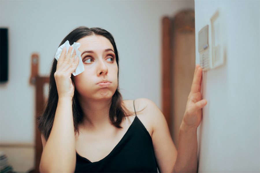Woman looking at Thermostat
