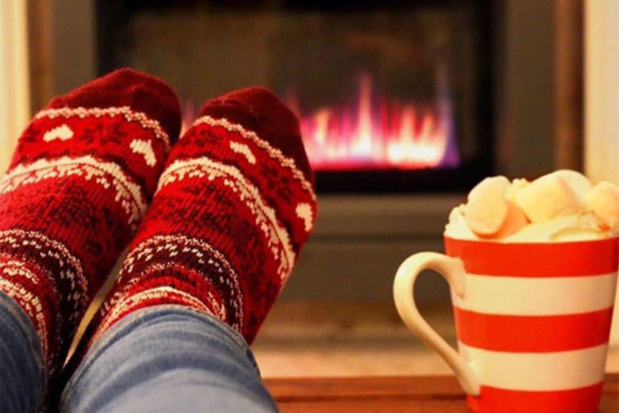 Feet in Socks and Fireplace in background